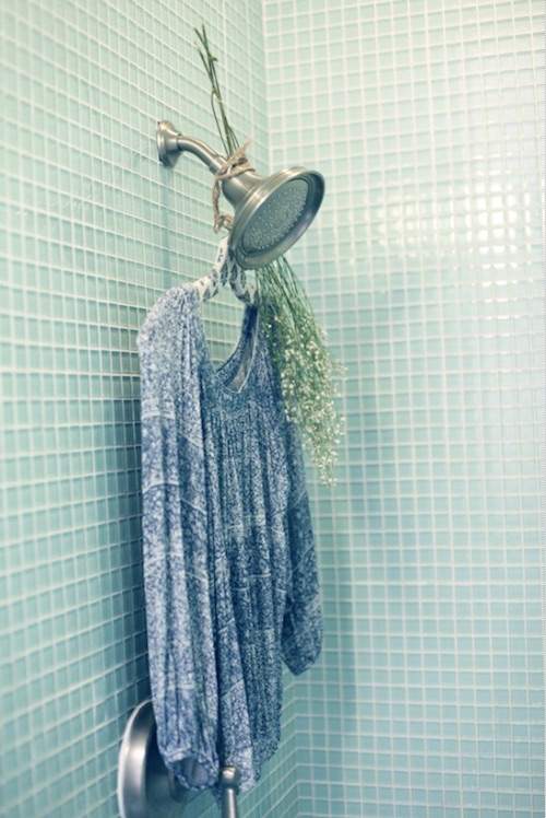 une tunique froissée suspendue dans la douche pour la défroisser