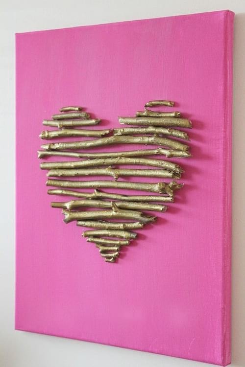 a canvas made with painted twig hearts