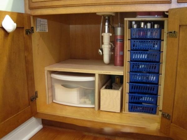 storage has been fitted under the sink to optimize space