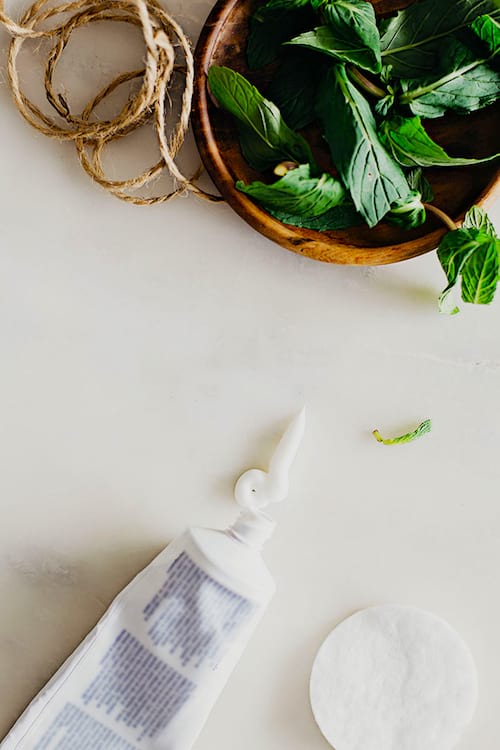 Une femme qui utilise du dentifrice pour soigner un piqûre de moustique.