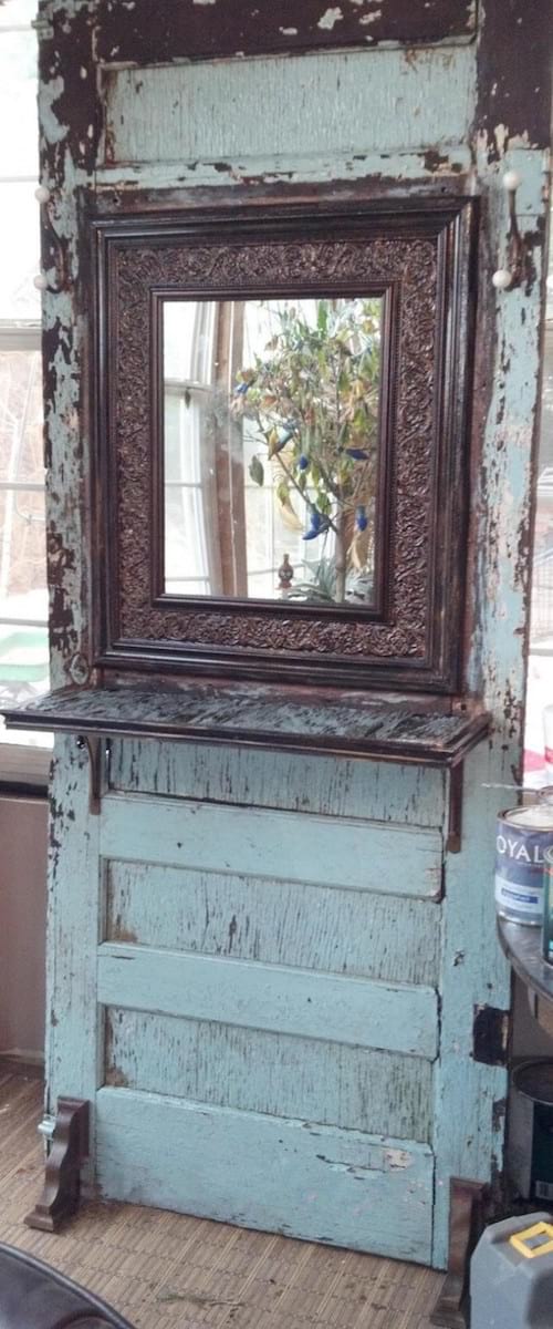 Upcycling idea: an old door recycled into a large mirror with shelf.