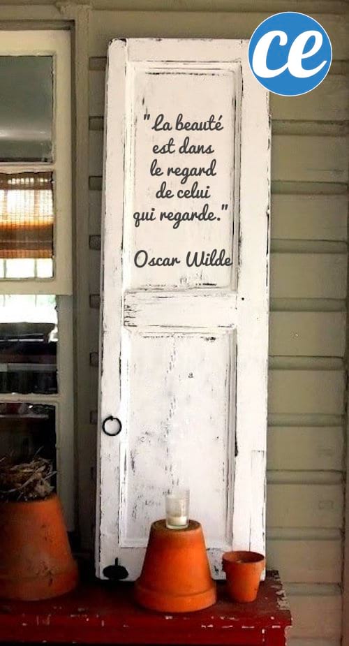Upcycling idea: an old door recycled as a garden decoration with an inspiring quote.