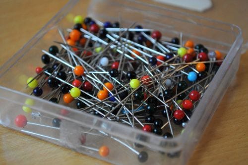 A box of pins to easily repair a tear on a sweater.