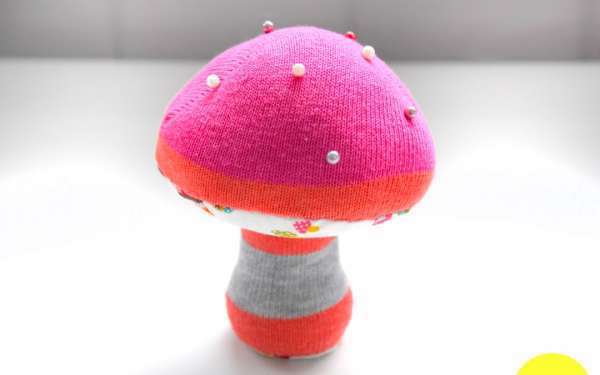 un coussin à épingles champignon fait avec une chaussette dépareillée