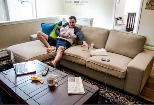 bébé est endormi dans les bras de papa et impossible d'attraper le téléphone