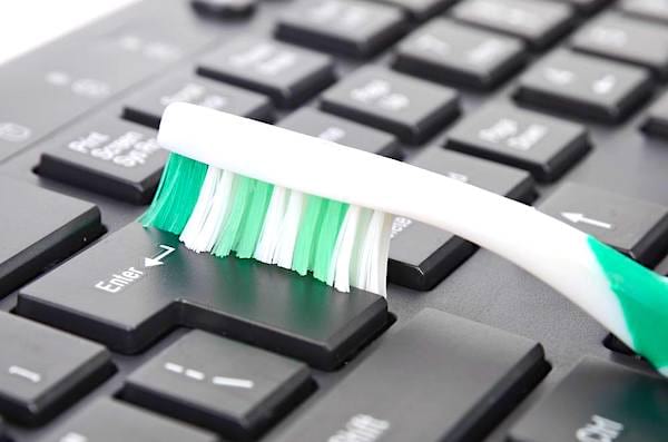 L'astuce facile pour nettoyer entre les touches de votre clavier : une vieille brosse à dents !