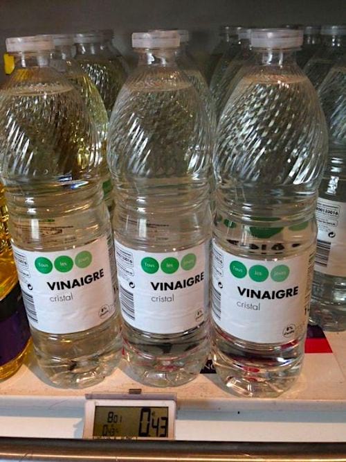 cheap bottles of white vinegar on a supermarket shelf