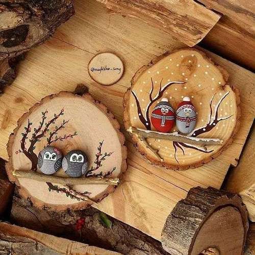 Two wooden logs painted with owls