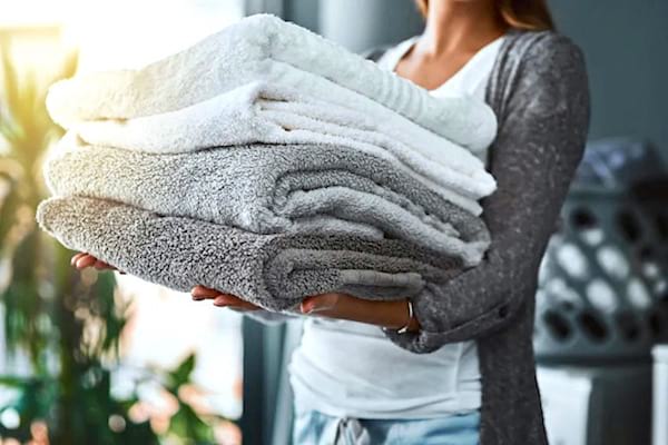 Blonde woman wearing white soft absorbent towels 