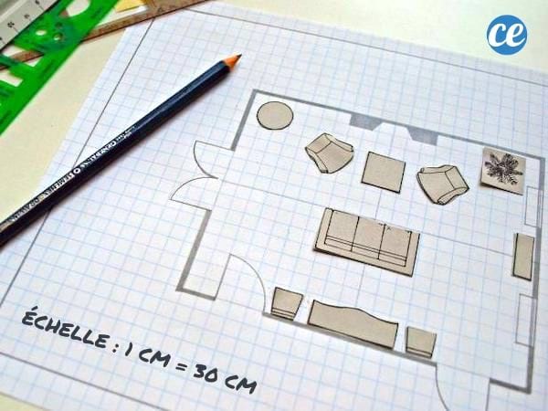 Du papier quadrillé et un crayon sur un plan d'aménagement d'intérieur.