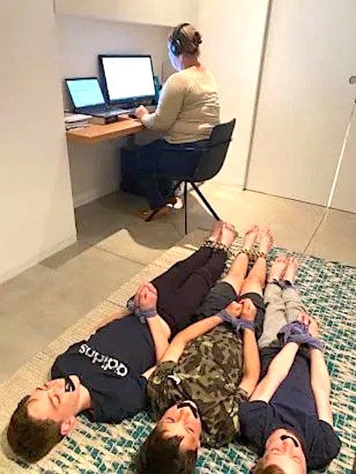 Maman qui travaille à la maison et des enfants sur le sol qui sont menottés