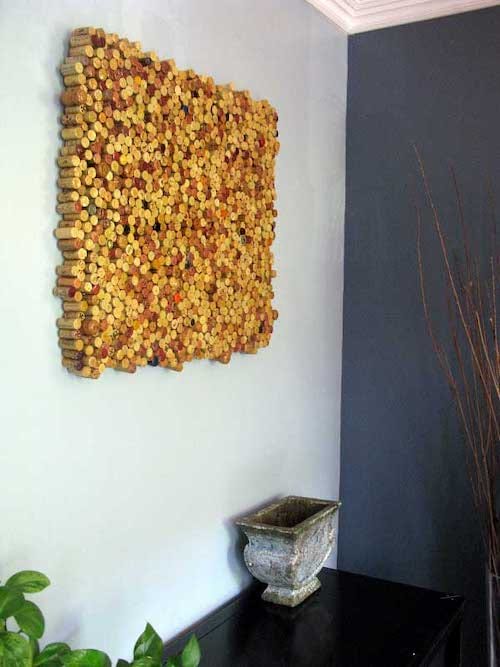 Wall mounted square with several corks on a wall 