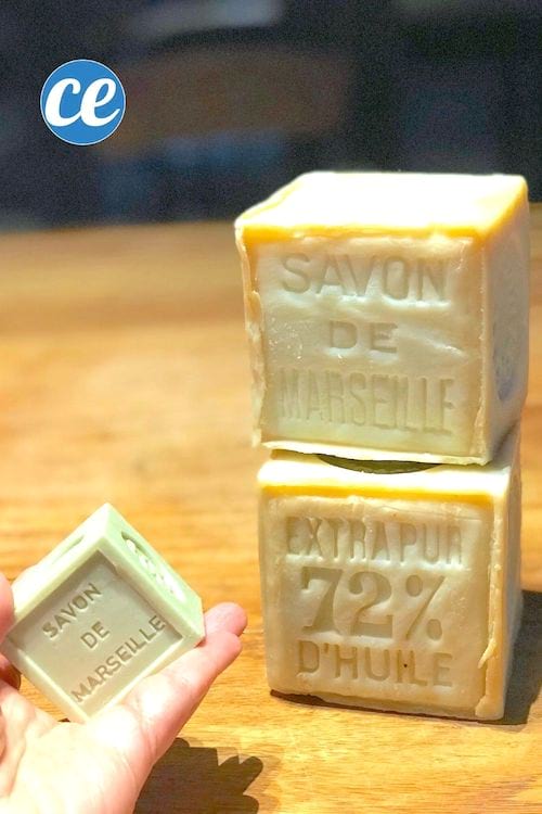 Deux gros blocs de savon de Marseille et un petit bloc sur une table en bois