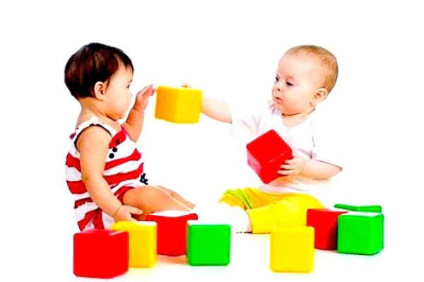 Deux bébés qui jouent avec des jouets propres et désinfectés à l'eau oxygénée.