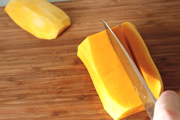 Un couteau qui coupe une courge sur une plancche à déccouper