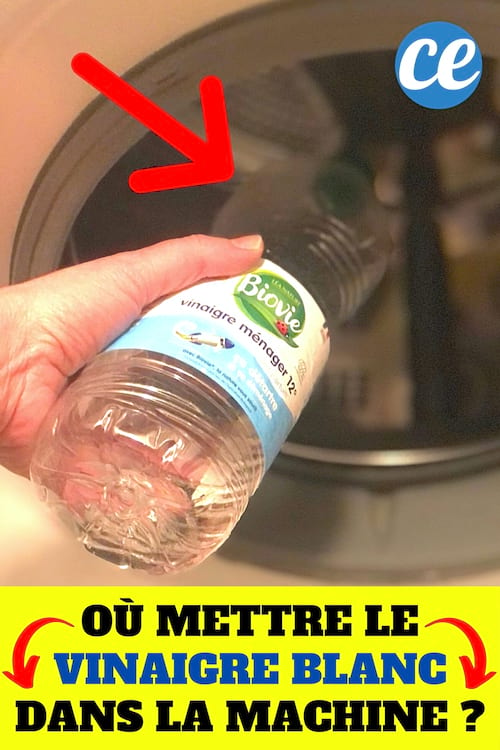 Une bouteille de vinaigre blanc versée dans le tambour de la machine à laver pour la nettoyer et détartrer