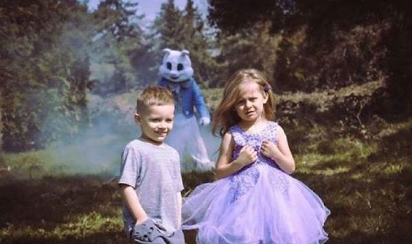 Deux enfants lors de pâques avec une mascotte terrifiante en arrière-plan 