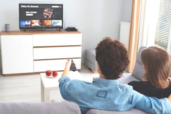 A living room with a TV and internet box that consumes electricity