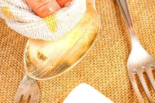 Une cuillère en acier inoxydable nettoyée avec de l'huile d'olive pour la faire briller