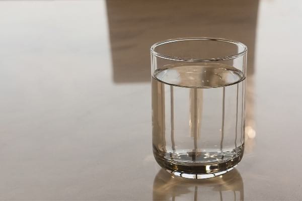 glass of water on a brown table