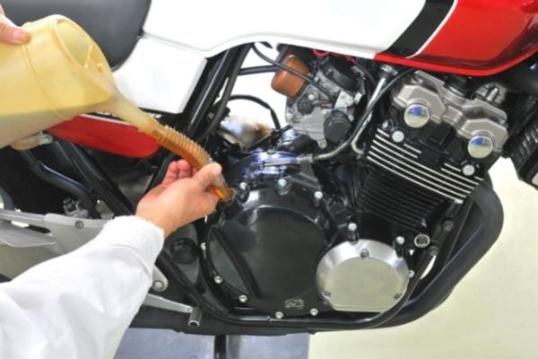 Oil added to a motorcycle engine to reduce fuel consumption