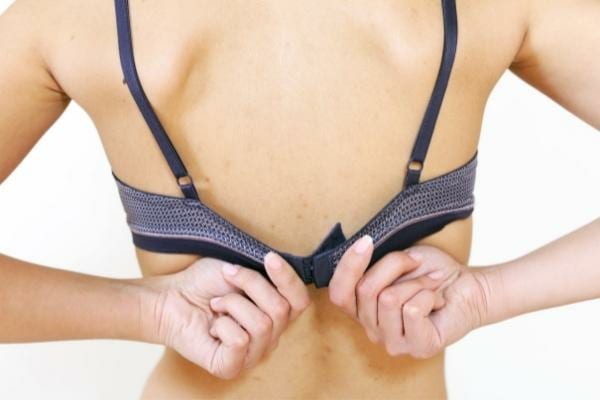 Une femme dégrafant son soutien-gorge