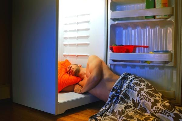 A man who sleeps with his head in a refrigerator to cool off