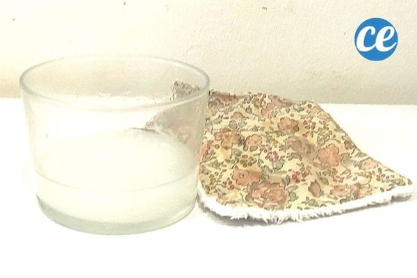 de l'eau de cuisson de riz dans un petit bol transparent avec une lingette en tissu
