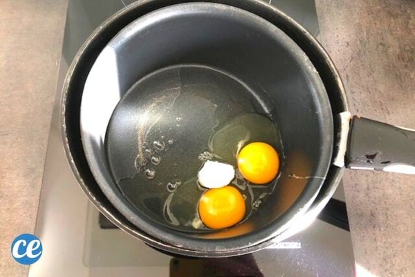 two eggs and cream in a pan
