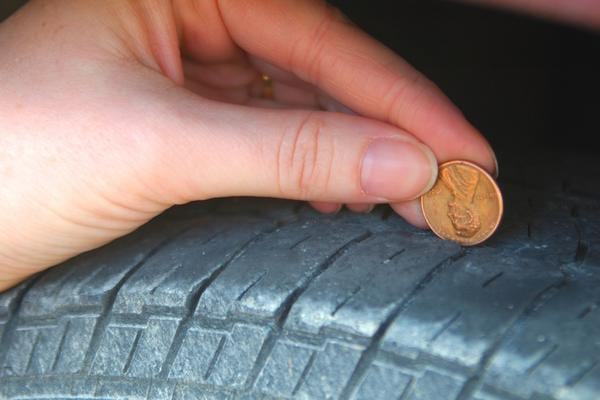 Un test d'usure de pneu fait avec une pièce pour savoir quand il faut le changer