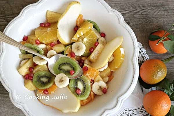 A winter fruit salad in a white chair with the clementines on the coast 