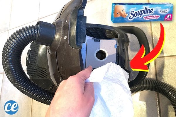 Un aspirateur noir ouvert avec de la soupline à proximité 