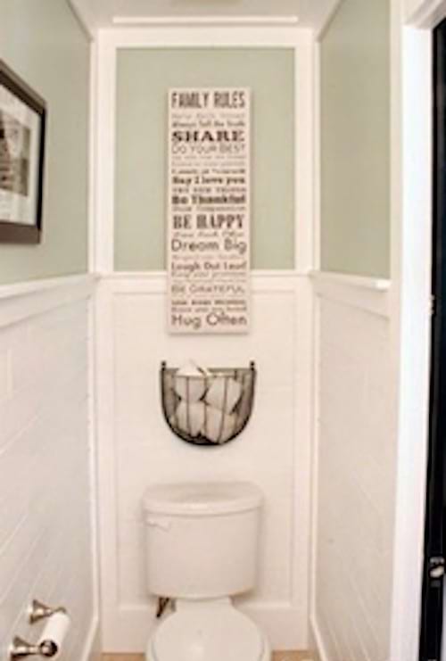 Very simplistic toilets with an olive-colored wall and the other part in white 