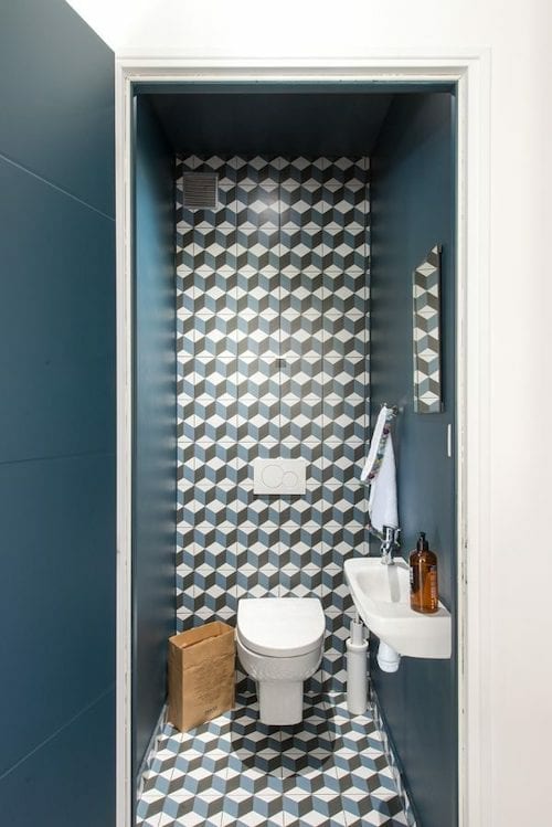 Blue toilets with wallpaper featuring 3D blue cubes