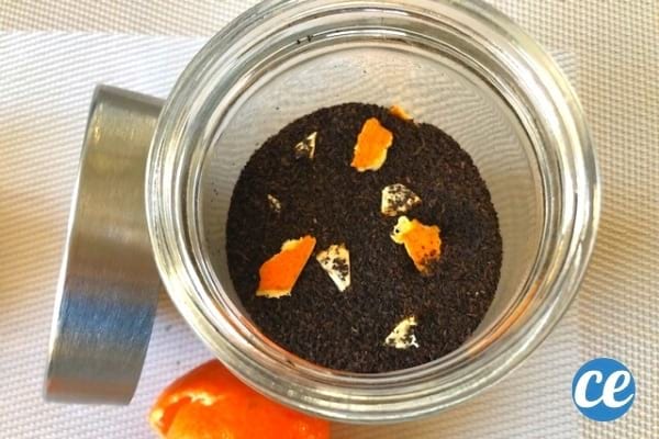 Glas loser schwarzer Tee mit Orangenschalen darin