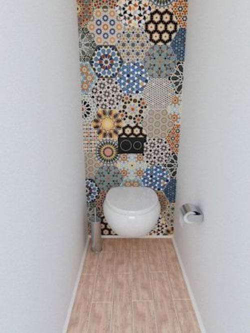 Toilets with colorful hexagonal tiles on the wall