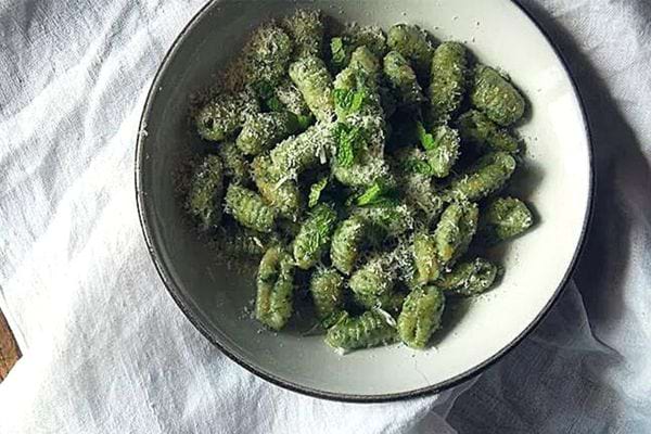 A plate filled with nettle gnocchi