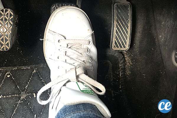 Le pied d'une personne sur la pédale de frein 