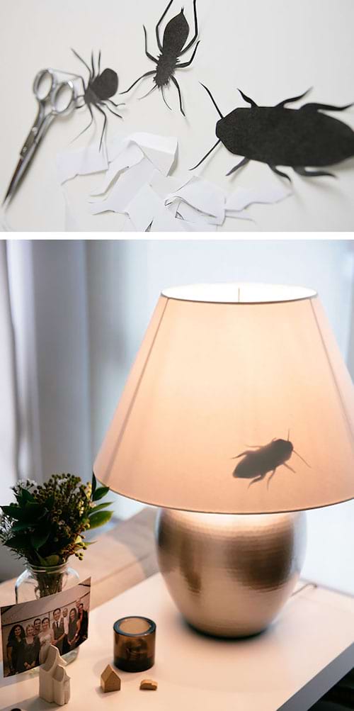 Plusieurs faux insectes en papier sur une lampe 
