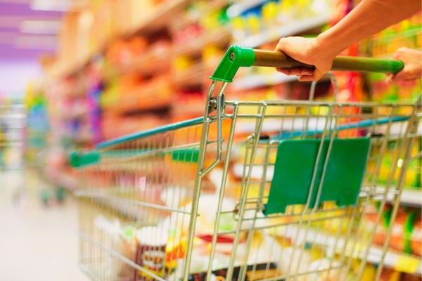 Un homme qui pousse un caddie pour chercher des produits anti inflation