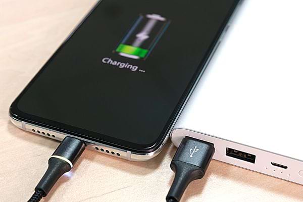 Un téléphone qui charge à l'aide d'une batterie externe