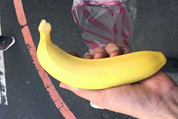 Une personne tenant une banane