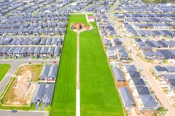 Un grand quartier avec plusieurs maisons grise autour d'une maison rouge