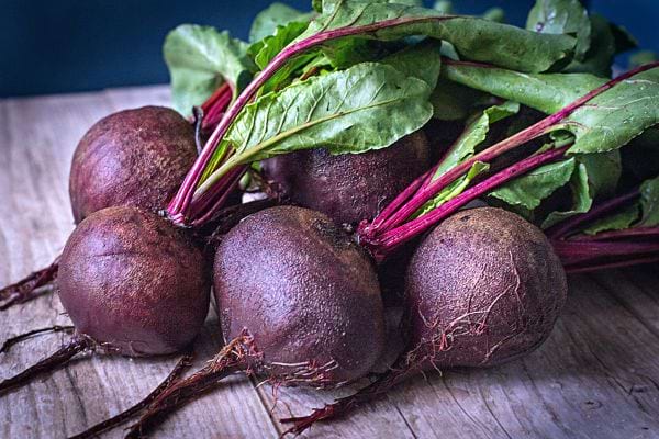 Several beets on a wooden table 