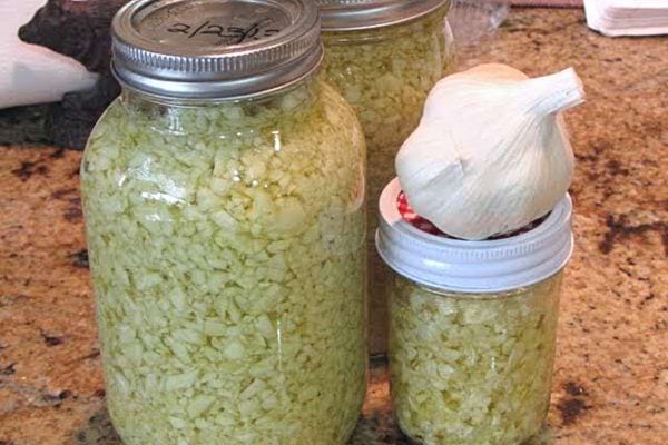 Plusieurs bocaux en verre grand et petit contenant de l’ail écrasé