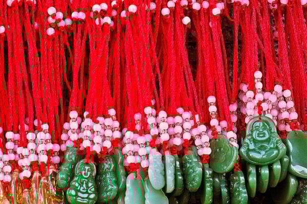 Plusieurs bracelets rouges avec des pierres vertes