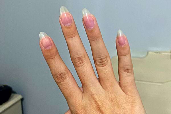 La main d'une personne avec des ongles en forme d'amande