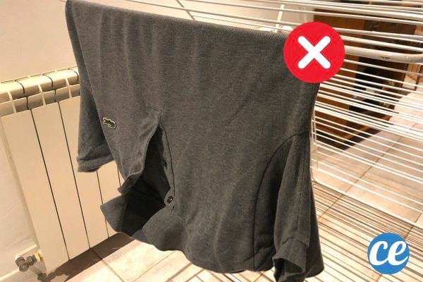 un polo étendu à cheval sur les fils de l'étendage