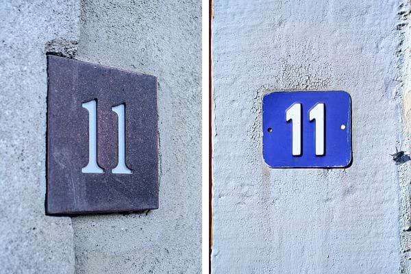 Plaques "11", gauche pierre gravée, droite métal bleu sur fond blanc, signifiant diversité.