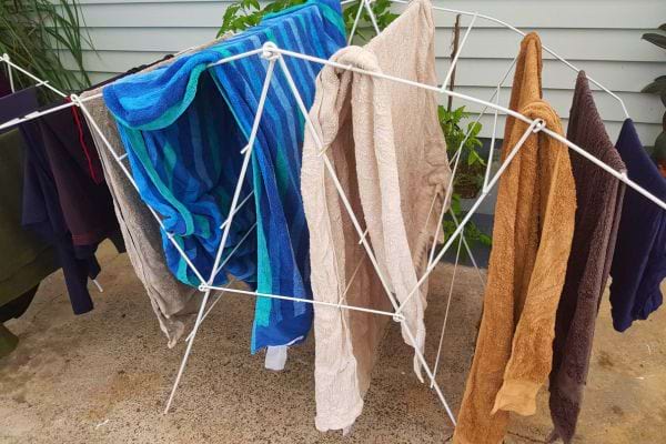 Linge humide sur un étendoir à l'extérieur durant le jour, risque de rosée nocturne.
